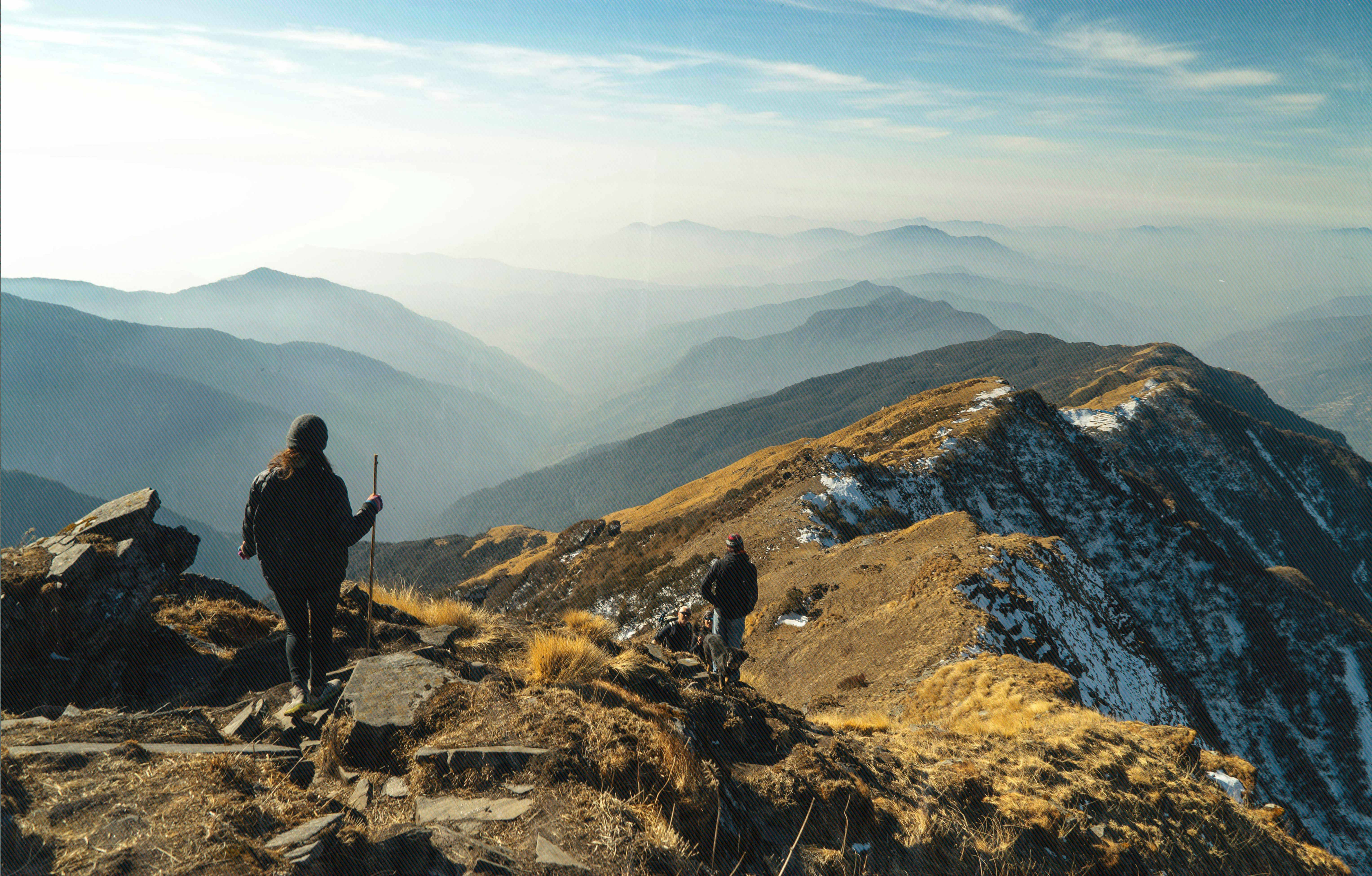 Hikers on a mountain ridge with panoramic views of Colorado mountains