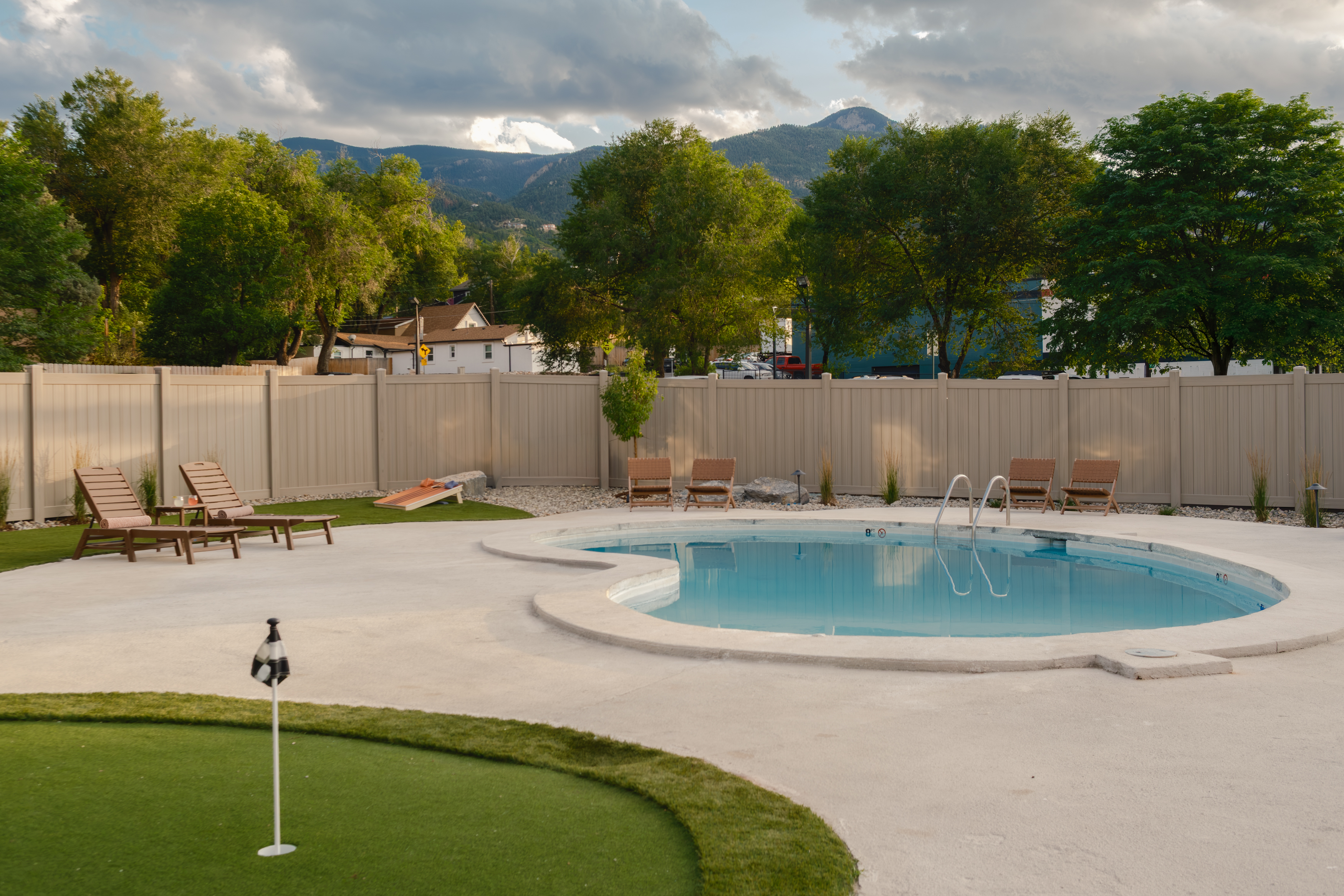 Outdoor pool, putting green, and mountain views at The Outrider Hotel