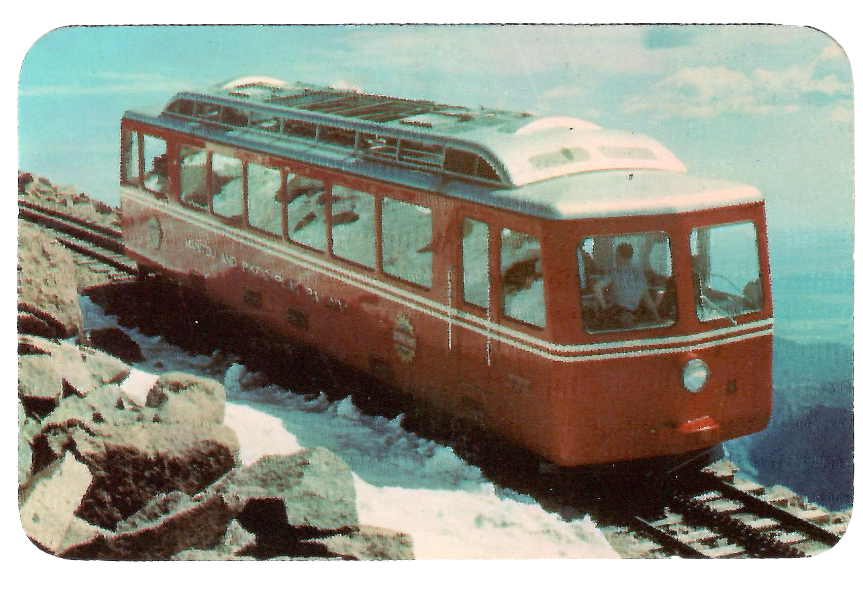 Vintage postcard of the Pikes Peak Cog Railway train ascending to the summit near Manitou Springs Colorado