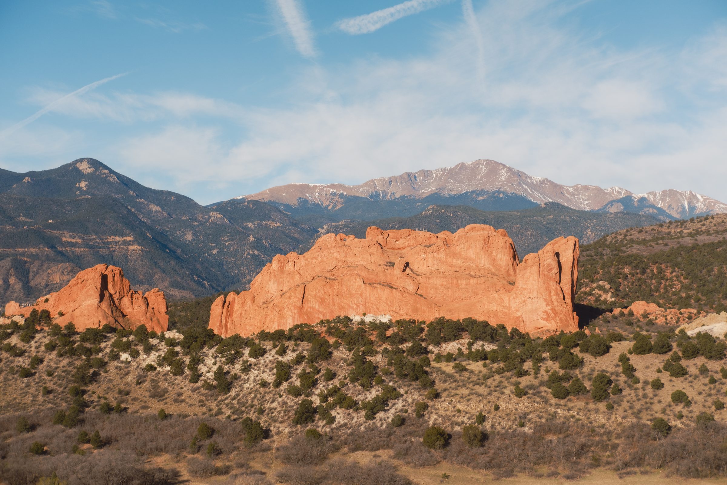 Red rock formations below a snow-capped Pikes Peak near Manitou Springs, Colorado