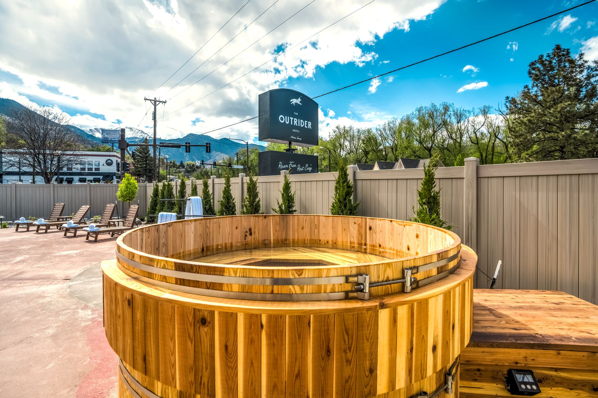 Outdoor cedar hot tub at The Outrider Hotel with Pikes Peak in the distance, Manitou Springs